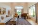 Inviting living room filled with natural light, comfortable seating, and a classic piano at 8230 E Wood Dr, Scottsdale, AZ 85260