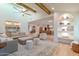 Spacious living room with vaulted ceilings, comfortable seating, bar, and decorative shelving at 8230 E Wood Dr, Scottsdale, AZ 85260