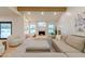 Bright living room with comfortable seating, fireplace, and large windows offering natural light at 8230 E Wood Dr, Scottsdale, AZ 85260