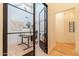 Bright office features modern doors, light wood floors, desk, and decorative items at 8230 E Wood Dr, Scottsdale, AZ 85260