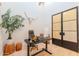 Contemporary office featuring glass doors, desk, plants, and longhorn skull at 8230 E Wood Dr, Scottsdale, AZ 85260