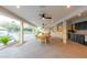 Covered patio with outdoor kitchen, ceiling fans, and a dining table, perfect for alfresco entertaining and dining at 8230 E Wood Dr, Scottsdale, AZ 85260
