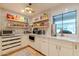 Pantry with custom shelving stocked with goods, white cabinets, and ample countertop space at 8230 E Wood Dr, Scottsdale, AZ 85260