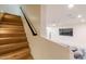 Wooden staircase leading to a finished basement with an entertainment area and modern design at 8230 E Wood Dr, Scottsdale, AZ 85260
