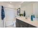 Bright bathroom features a modern vanity with gray cabinets and a shower-tub combo at 8251 E Petunia Ave, Mesa, AZ 85212