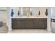 Elegant bathroom featuring dual vanities, modern cabinetry, and stylish mirrors at 8251 E Petunia Ave, Mesa, AZ 85212