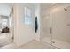 Bright bathroom featuring a glass-enclosed shower, modern fixtures, and a towel warmer at 8251 E Petunia Ave, Mesa, AZ 85212