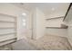 Walk-in closet with shelving, rod hanging, and an ottoman at 8251 E Petunia Ave, Mesa, AZ 85212
