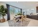 Bright dining room with a modern table, seating for four, natural light, and elegant decor at 8251 E Petunia Ave, Mesa, AZ 85212