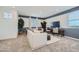 Inviting living room showcasing a comfortable sofa, modern desk, and bright natural light at 8251 E Petunia Ave, Mesa, AZ 85212