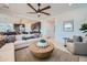 Cozy living room featuring modern furnishings, a large sectional sofa, and an inviting atmosphere with a glimpse of the kitchen at 8251 E Petunia Ave, Mesa, AZ 85212