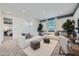 Spacious living room with large sectional sofa, stylish decor, and abundant natural light at 8251 E Petunia Ave, Mesa, AZ 85212