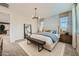 Comfortable main bedroom featuring a stylish bed, a full-length mirror, and serene color palette at 8251 E Petunia Ave, Mesa, AZ 85212