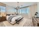 Relaxing main bedroom featuring a cozy bed, bench, and serene wallpaper design at 8251 E Petunia Ave, Mesa, AZ 85212
