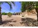 Expansive backyard with desert landscaping, mature trees, and partial view of a covered patio attached to the home at 863 Leisure World --, Mesa, AZ 85206