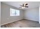 Bedroom featuring wood-style floors, a ceiling fan, and a window offering bright natural light at 863 Leisure World --, Mesa, AZ 85206