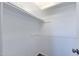 A walk-in closet with white walls and shelves, providing ample storage space at 863 Leisure World --, Mesa, AZ 85206