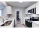 Renovated kitchen featuring stainless steel appliances, bright white cabinets, quartz countertops and a large pantry at 863 Leisure World --, Mesa, AZ 85206