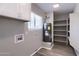 Laundry room with cabinets, shelving, and a hot water heater, with a bright window at 863 Leisure World --, Mesa, AZ 85206
