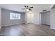 Open-concept living room with laminate flooring, fresh paint, ceiling fan, and bright window at 863 Leisure World --, Mesa, AZ 85206