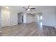 Fresh open-concept living room with laminate flooring, fresh paint, and updated ceiling fan at 863 Leisure World --, Mesa, AZ 85206