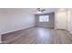 Living room with new gray laminate flooring, fresh gray paint, ceiling fan, and bright window at 863 Leisure World --, Mesa, AZ 85206