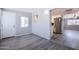 Fresh, open living room showing doorway to kitchen with stainless steel refrigerator, fresh paint, and laminate floors at 863 Leisure World --, Mesa, AZ 85206