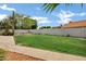 Landscaped backyard featuring a manicured lawn and mature trees at 8913 S Forest Ave, Tempe, AZ 85284