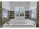 Bright bathroom with an oval tub and shuttered window at 8913 S Forest Ave, Tempe, AZ 85284