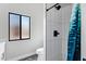 Updated bathroom showing a shower with white tiling and black fixtures at 8913 S Forest Ave, Tempe, AZ 85284
