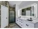 Elegant bathroom featuring double sinks, decorative mirror, and updated shower at 8913 S Forest Ave, Tempe, AZ 85284