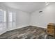 Inviting bedroom with wood-style flooring, shutters, and ample natural light at 8913 S Forest Ave, Tempe, AZ 85284