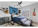 Comfortable bedroom with a ceiling fan, electric guitars and cozy decor at 8913 S Forest Ave, Tempe, AZ 85284
