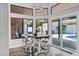 Bright breakfast nook features an elegant table with seating and clerestory windows with a pool view at 8913 S Forest Ave, Tempe, AZ 85284