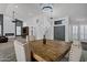 Open dining room features a rustic wood table, stylish chairs and modern lighting fixture at 8913 S Forest Ave, Tempe, AZ 85284