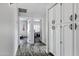 Hallway with built in cabinets and views into other rooms with wood floors at 8913 S Forest Ave, Tempe, AZ 85284