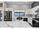 Bright kitchen featuring white cabinets, subway tile backsplash, quartz countertops, and stainless steel appliances at 8913 S Forest Ave, Tempe, AZ 85284