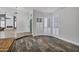 Bright and open living area with wood-style flooring, fireplace, and large windows with plantation shutters at 8913 S Forest Ave, Tempe, AZ 85284