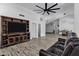 Bright living room featuring a rustic TV console, comfortable leather sofa, and an open floorplan at 8913 S Forest Ave, Tempe, AZ 85284