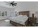 Main bedroom featuring hardwood floors, ceiling fan, and natural light at 8913 S Forest Ave, Tempe, AZ 85284