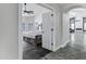 Open doorway showcasing a bright bedroom with hardwood floors and a ceiling fan at 8913 S Forest Ave, Tempe, AZ 85284