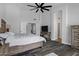 Spacious main bedroom with hardwood floors, ceiling fan, and ensuite access at 8913 S Forest Ave, Tempe, AZ 85284