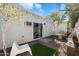 Secluded backyard with pavers, a dining set, privacy fence, and lush greenery at 905 E Coronado Rd, Phoenix, AZ 85006
