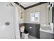Well-lit bathroom features a shower, sink, modern fixtures and white and gray accent tiling at 905 E Coronado Rd, Phoenix, AZ 85006
