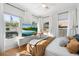 Bedroom boasts multiple windows, a TV, light hardwood floors, and modern decor at 905 E Coronado Rd, Phoenix, AZ 85006