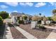 View of the house with driveway, gravel landscaping, a walkway to the front door, and clear blue skies at 905 E Coronado Rd, Phoenix, AZ 85006