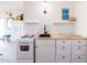 Cozy kitchen with white cabinets, stainless steel appliances, and butcher block countertop at 905 E Coronado Rd, Phoenix, AZ 85006