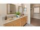 Bathroom with double sinks, updated mirrors, and a view to the walk-in closet at 93 S Sandstone St, Gilbert, AZ 85296
