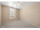 Bright carpeted bedroom with neutral paint, ceiling fan, and natural light at 93 S Sandstone St, Gilbert, AZ 85296