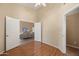 Light-filled bedroom with wood floors and open door to living space at 93 S Sandstone St, Gilbert, AZ 85296